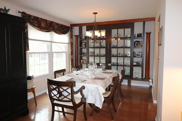 dining area featuring dark hardwood / wood-style flooring and a notable chandelier