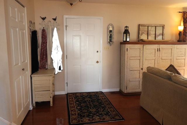 foyer entrance with dark hardwood / wood-style floors