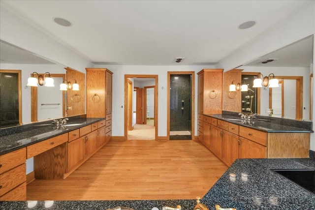 16001 Burr Oak Dr, Huntley, IL 60142 - bathroom featuring wood finished floors, baseboards, a stall shower, and two vanities