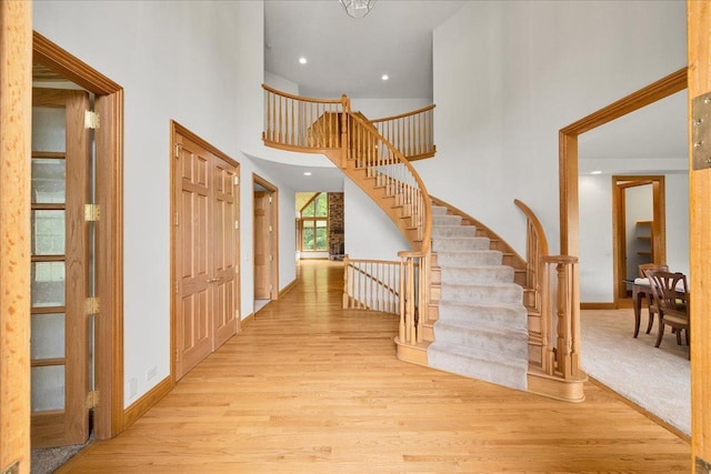 16001 Burr Oak Dr, Huntley, IL 60142 - foyer with wood finished floors, a high ceiling, stairway, baseboards, and recessed lighting