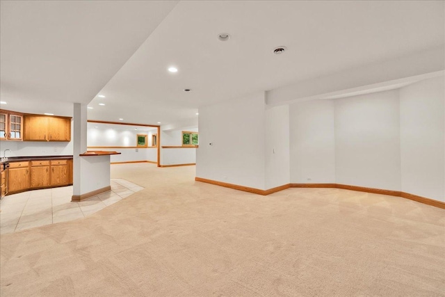 16001 Burr Oak Dr, Huntley, IL 60142 - kitchen featuring light colored carpet, dark countertops, recessed lighting, glass insert cabinets, and baseboards