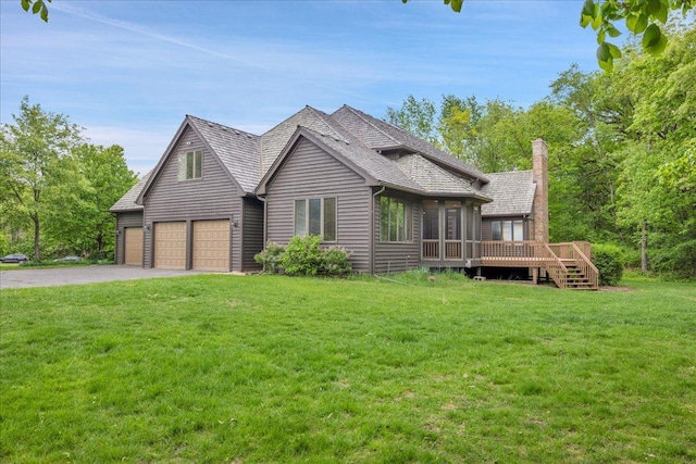 16001 Burr Oak Dr, Huntley, IL 60142 - view of front of home with driveway, an attached garage, a wooden deck, a front lawn, and a chimney