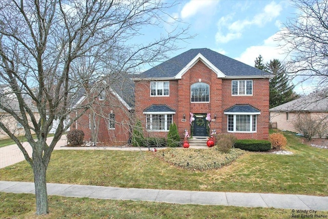 colonial-style house featuring a front lawn