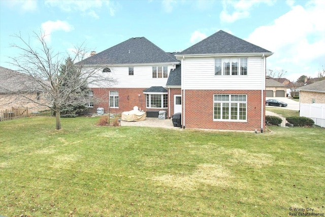 rear view of house with a yard and a patio