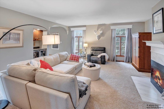 17224 Briar Dr, Tinley Park, IL 60487 - living area with a tiled fireplace, light carpet, beverage cooler, and arched walkways