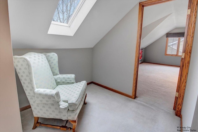 sitting room featuring light colored carpet and lofted ceiling