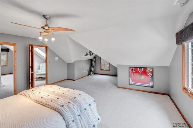 bedroom featuring light carpet, vaulted ceiling, and ceiling fan