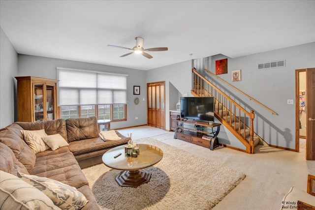 carpeted living room featuring ceiling fan