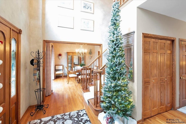 entryway featuring a chandelier and light hardwood / wood-style floors