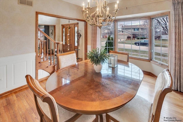 17224 Briar Dr, Tinley Park, IL 60487 - dining space with a chandelier, light wood-type flooring, wainscoting, and stairway