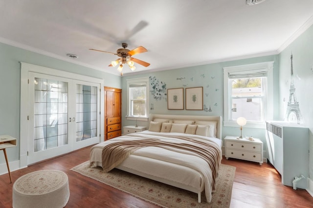 bedroom with ceiling fan, hardwood / wood-style floors, crown molding, and french doors