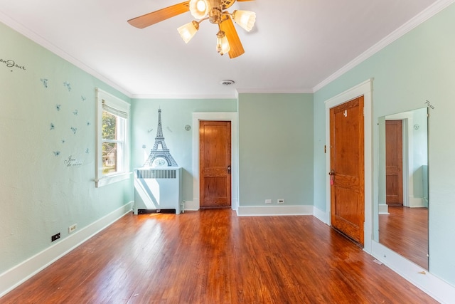 unfurnished bedroom with ceiling fan, wood-type flooring, and ornamental molding