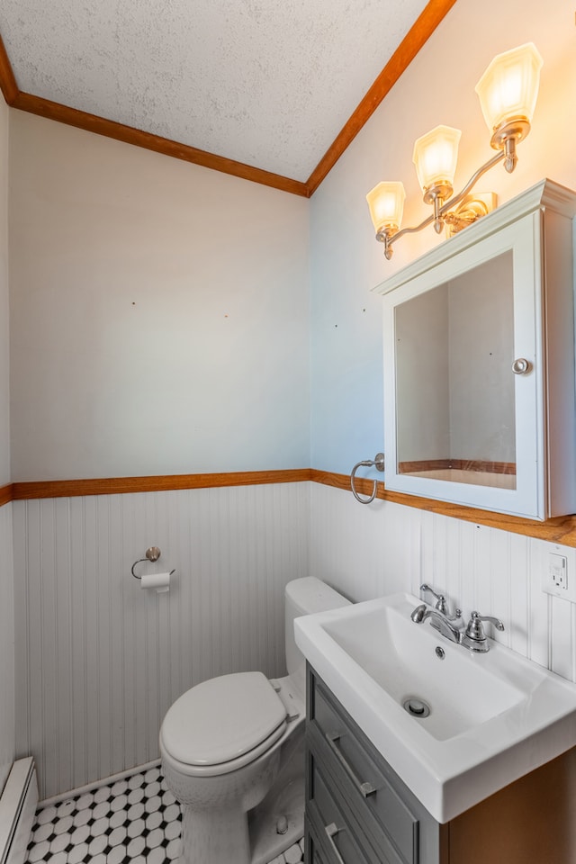 bathroom with a textured ceiling, wooden walls, crown molding, and a baseboard heating unit