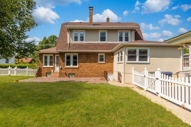 rear view of house with a lawn