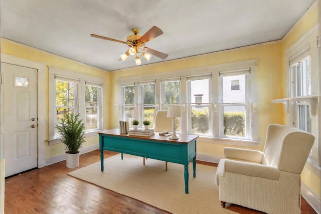 sunroom featuring ceiling fan