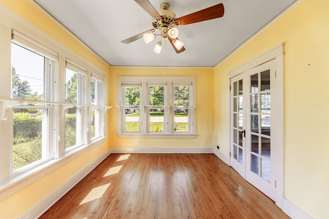 unfurnished sunroom with french doors and ceiling fan