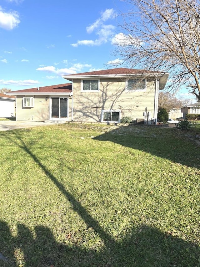 rear view of house with a yard