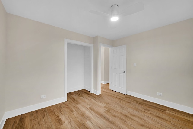 unfurnished bedroom with ceiling fan, light hardwood / wood-style flooring, and a closet