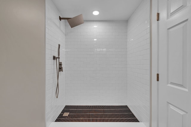 bathroom with a tile shower