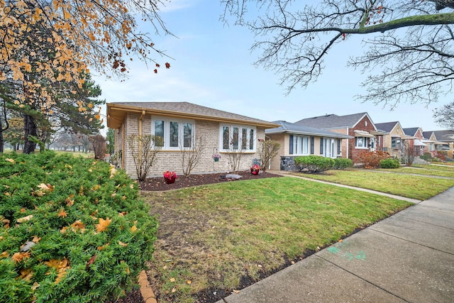 single story home featuring a front yard