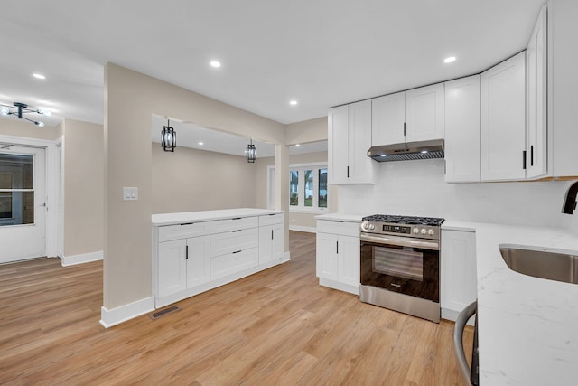 kitchen featuring white cabinets, light hardwood / wood-style floors, sink, and stainless steel range