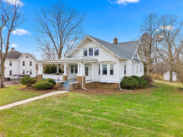 view of front facade featuring covered porch and a front yard