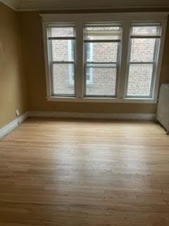 unfurnished room featuring wood finished floors and baseboards