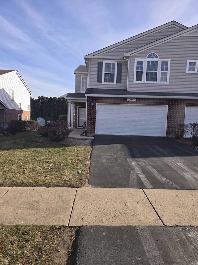 front of property featuring a front yard and a garage