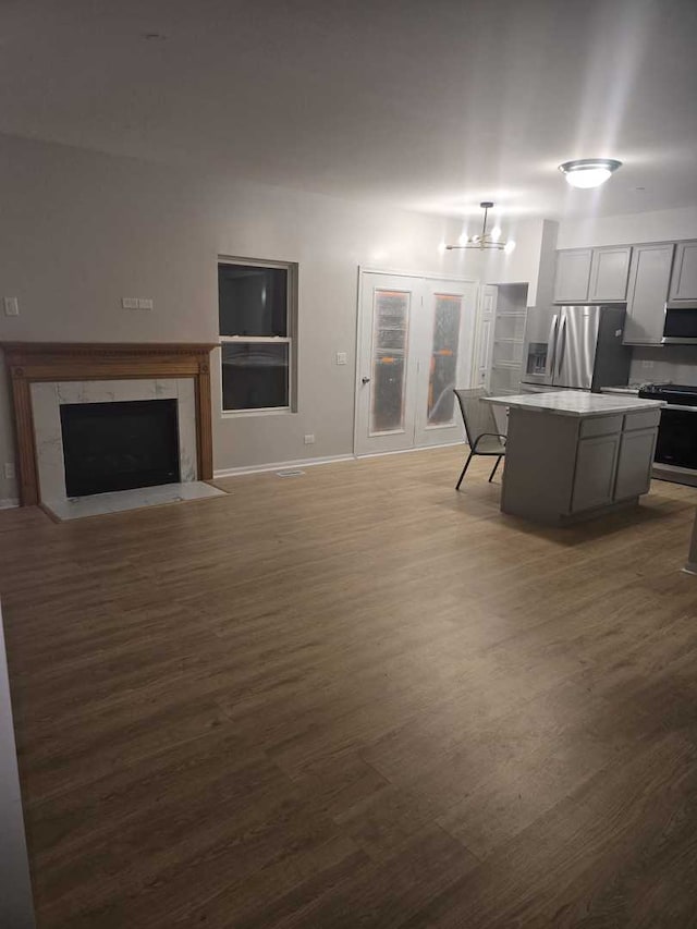 living room featuring dark hardwood / wood-style flooring and an inviting chandelier