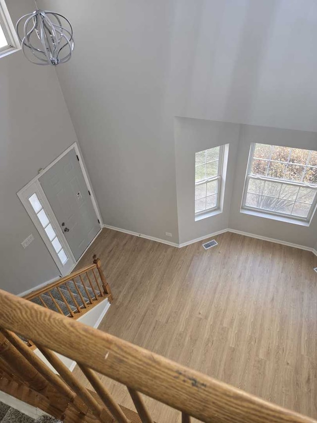 entryway featuring hardwood / wood-style floors and a notable chandelier