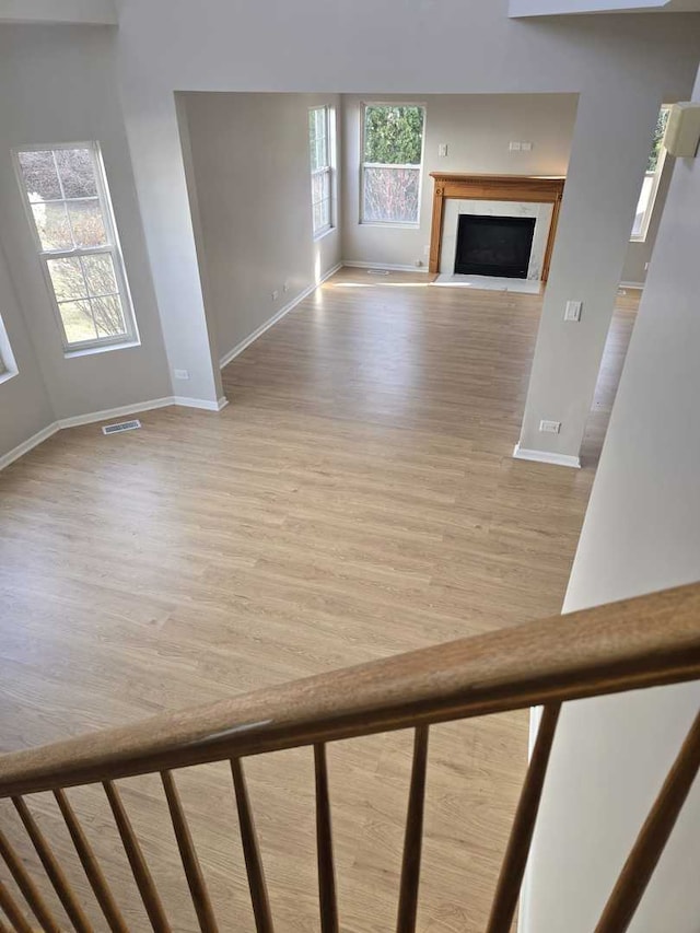 unfurnished living room with a fireplace and hardwood / wood-style floors