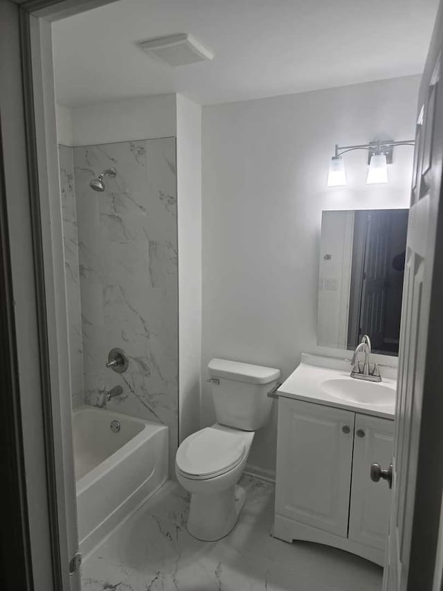 full bathroom featuring vanity, tiled shower / bath combo, and toilet