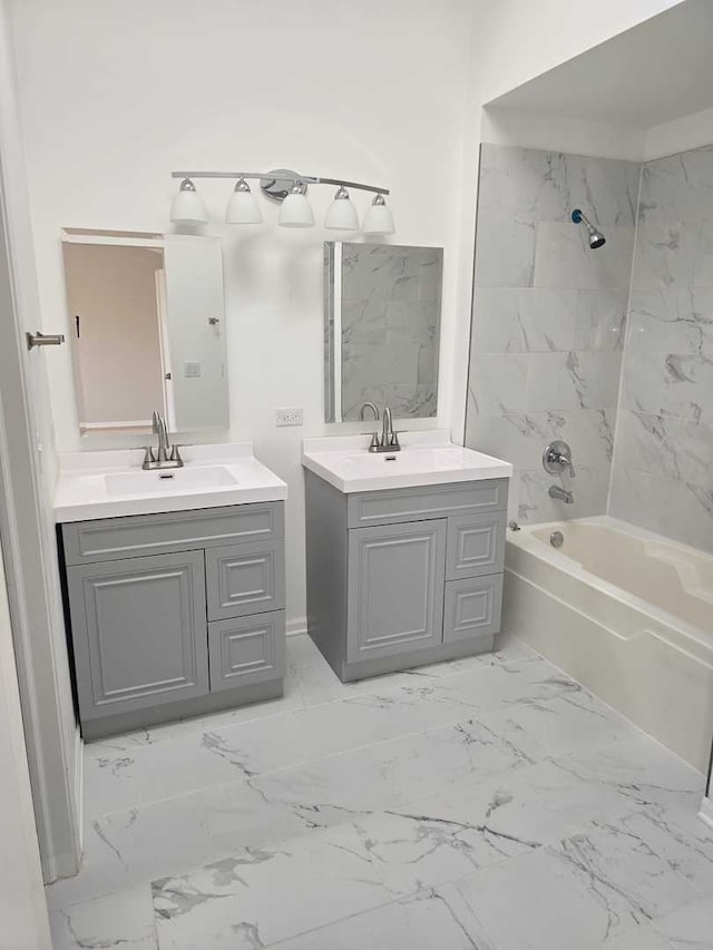 bathroom with vanity and tiled shower / bath