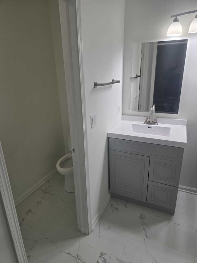 bathroom featuring vanity and toilet