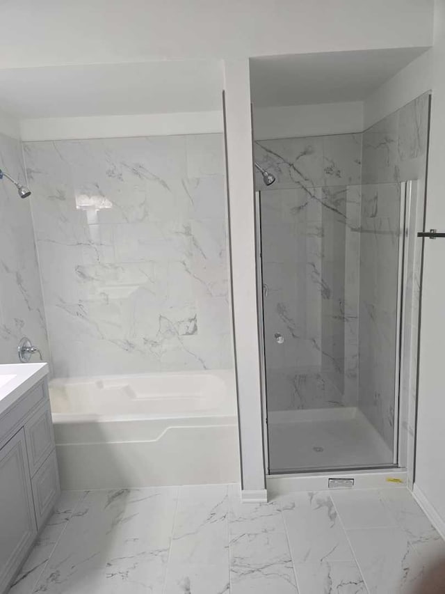 bathroom featuring vanity and shower with separate bathtub