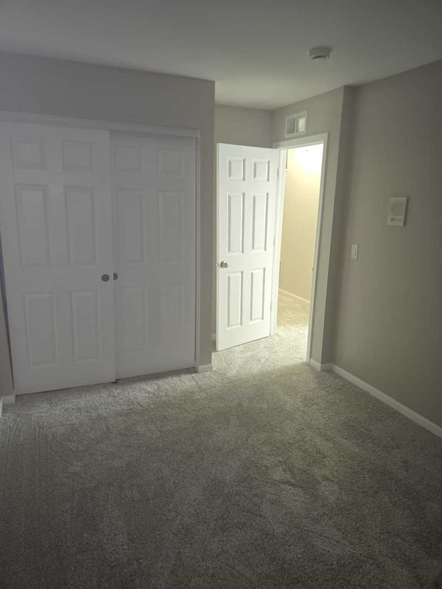 unfurnished bedroom with carpet and a closet