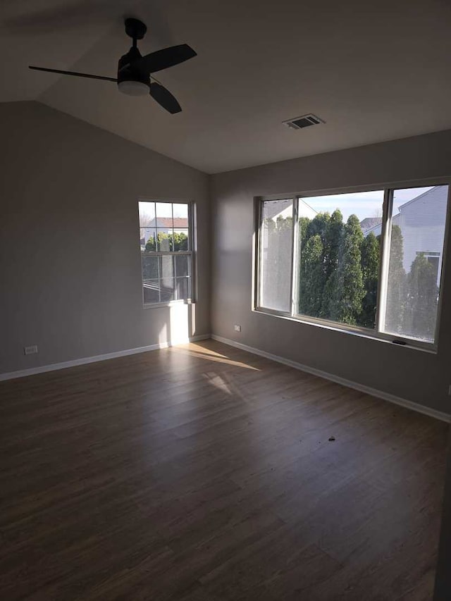 unfurnished room featuring dark hardwood / wood-style flooring, ceiling fan, and lofted ceiling