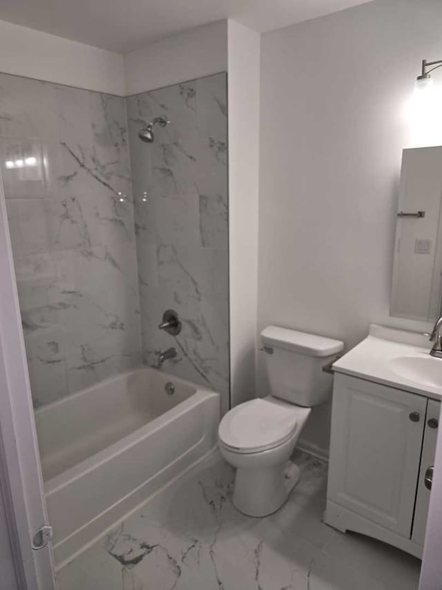 full bathroom featuring vanity, tiled shower / bath combo, and toilet