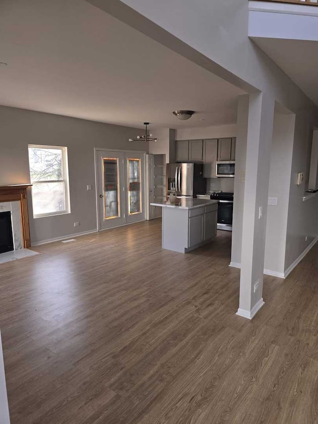 unfurnished living room with a premium fireplace and dark hardwood / wood-style flooring