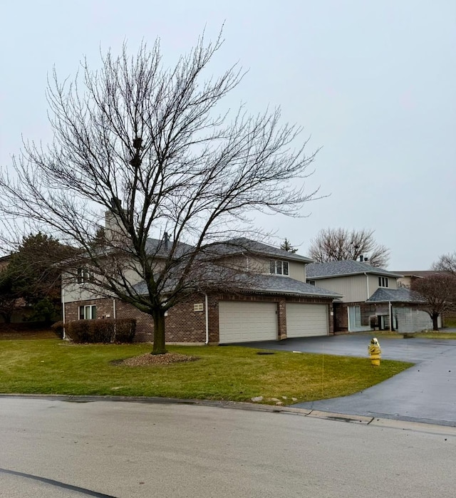 view of front of home with a front lawn and a garage