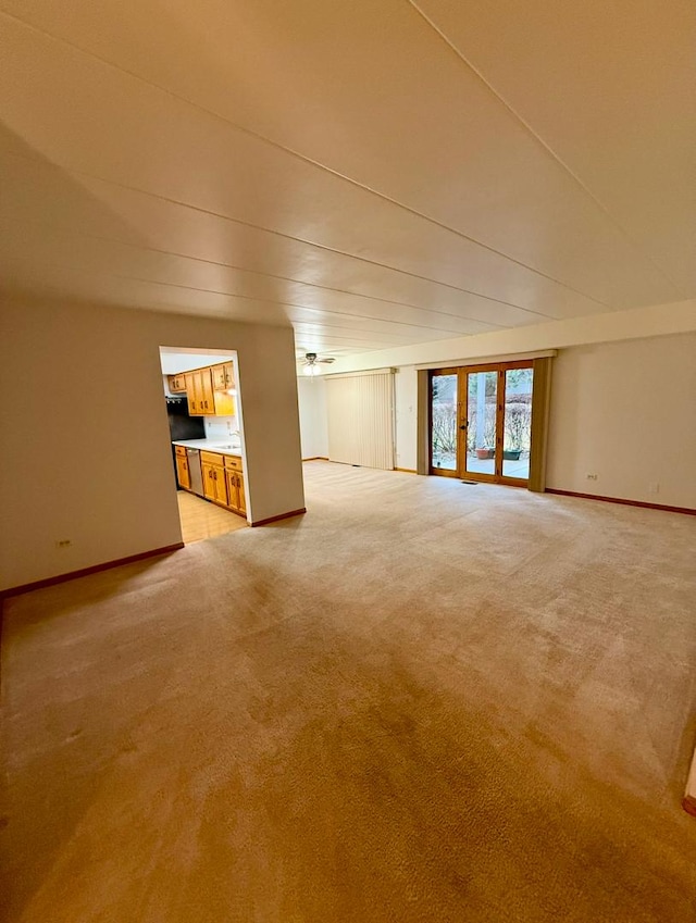 unfurnished living room featuring light colored carpet