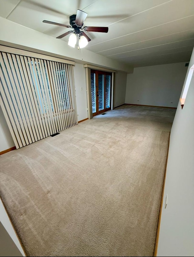 spare room featuring ceiling fan and carpet floors