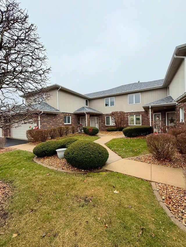 view of front of house with a front yard and a garage