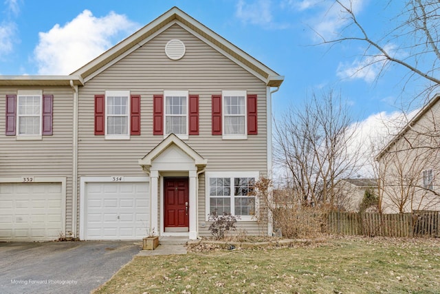 view of front of property with a garage and a front yard