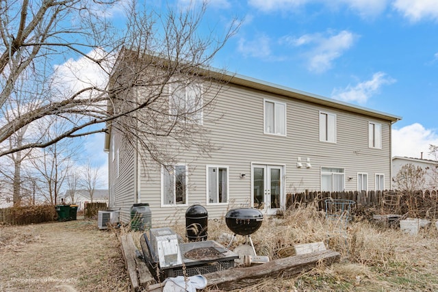 rear view of house with central air condition unit and french doors