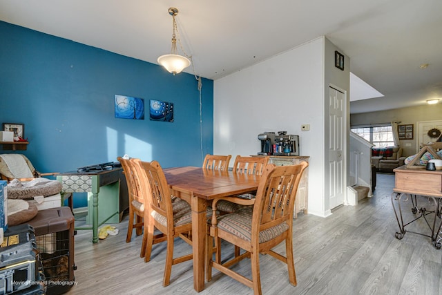 dining space with light hardwood / wood-style flooring