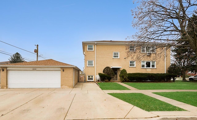 view of front of home featuring a garage and a front lawn