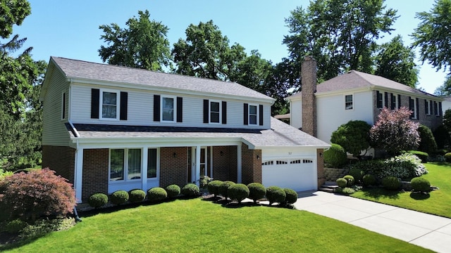 view of front of house featuring a garage and a front lawn