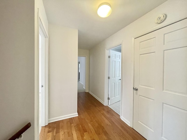 corridor with light hardwood / wood-style flooring