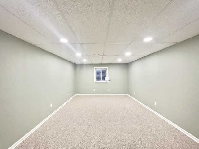 basement with carpet flooring and a drop ceiling